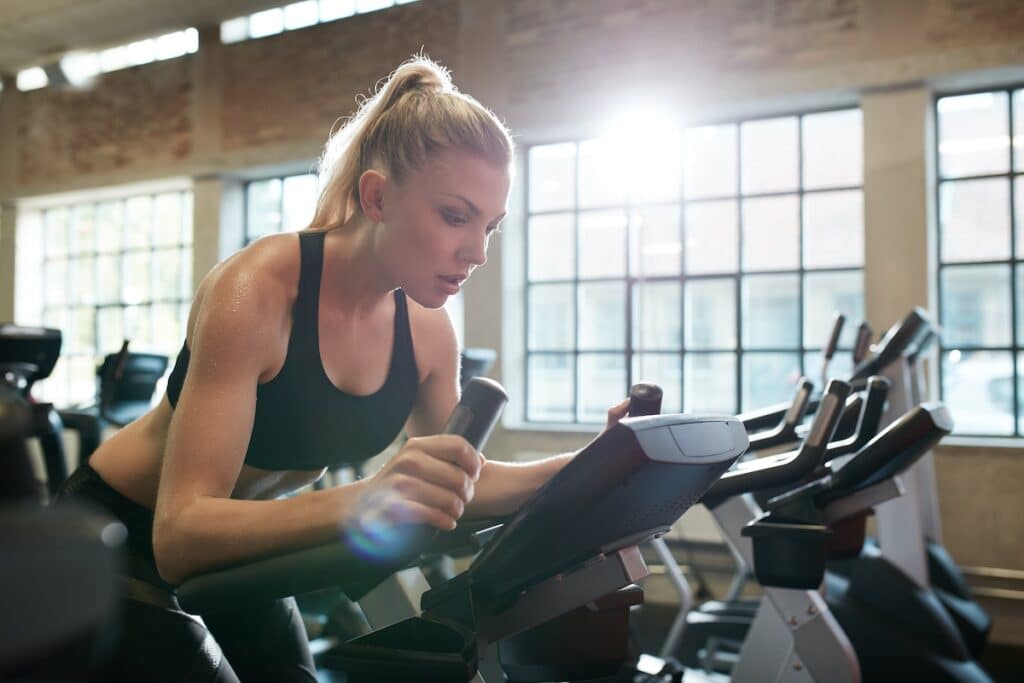Woman working out on exercise bike at the gym