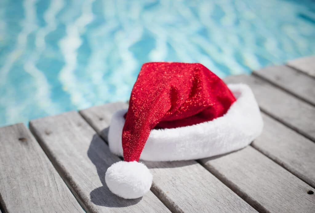 Santa hat on a deck by a pool