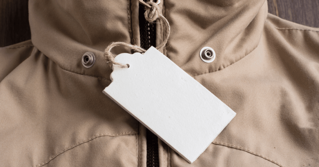 Beige hooded coat with a price tag hanging from the neck