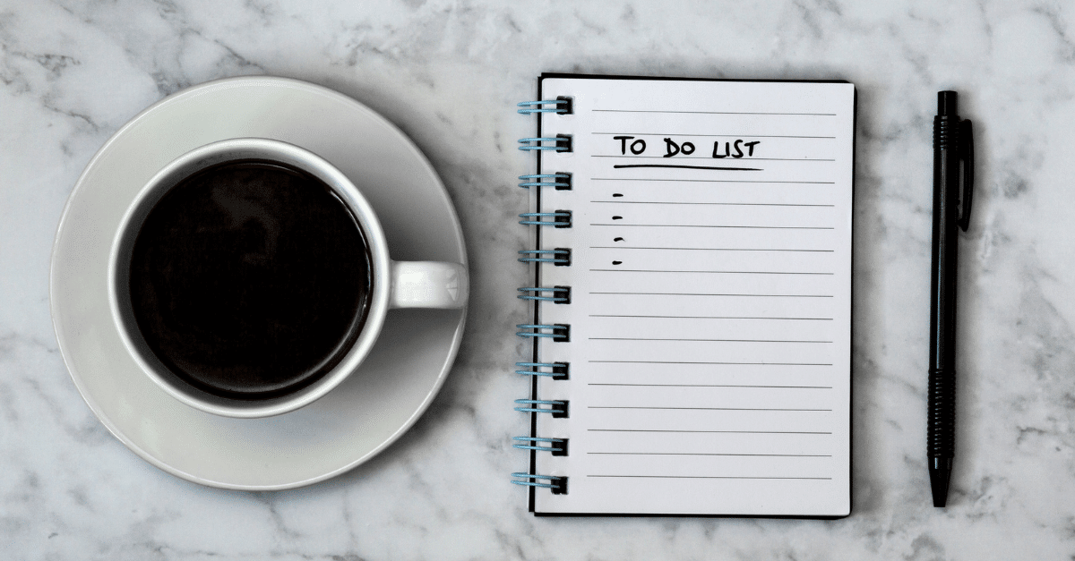 cup of coffee and to-do list with a pen on marble table