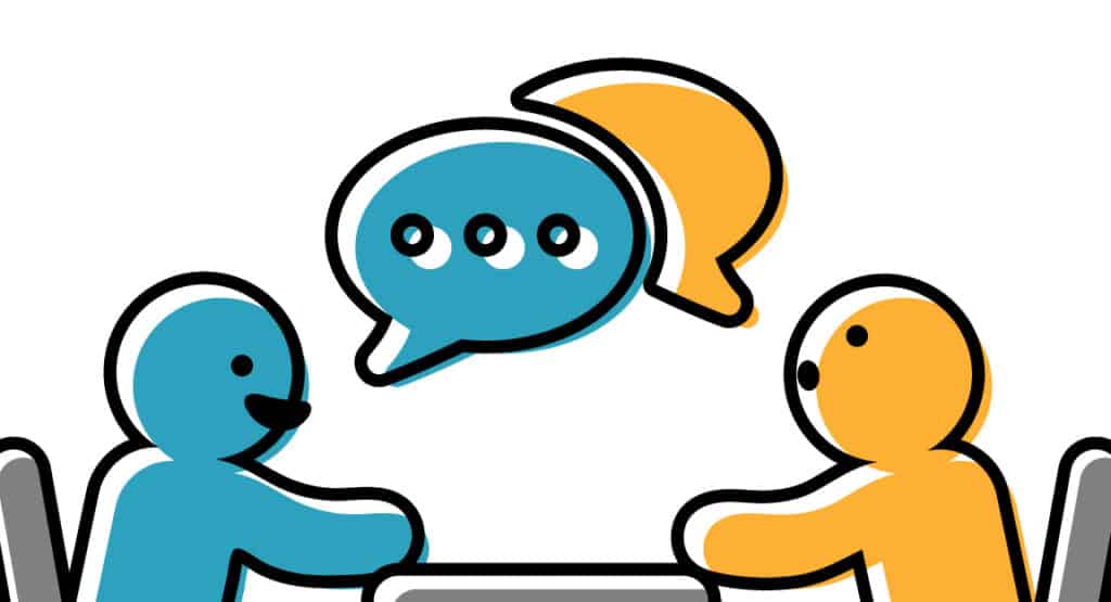 teal person and yellow person talking at a table